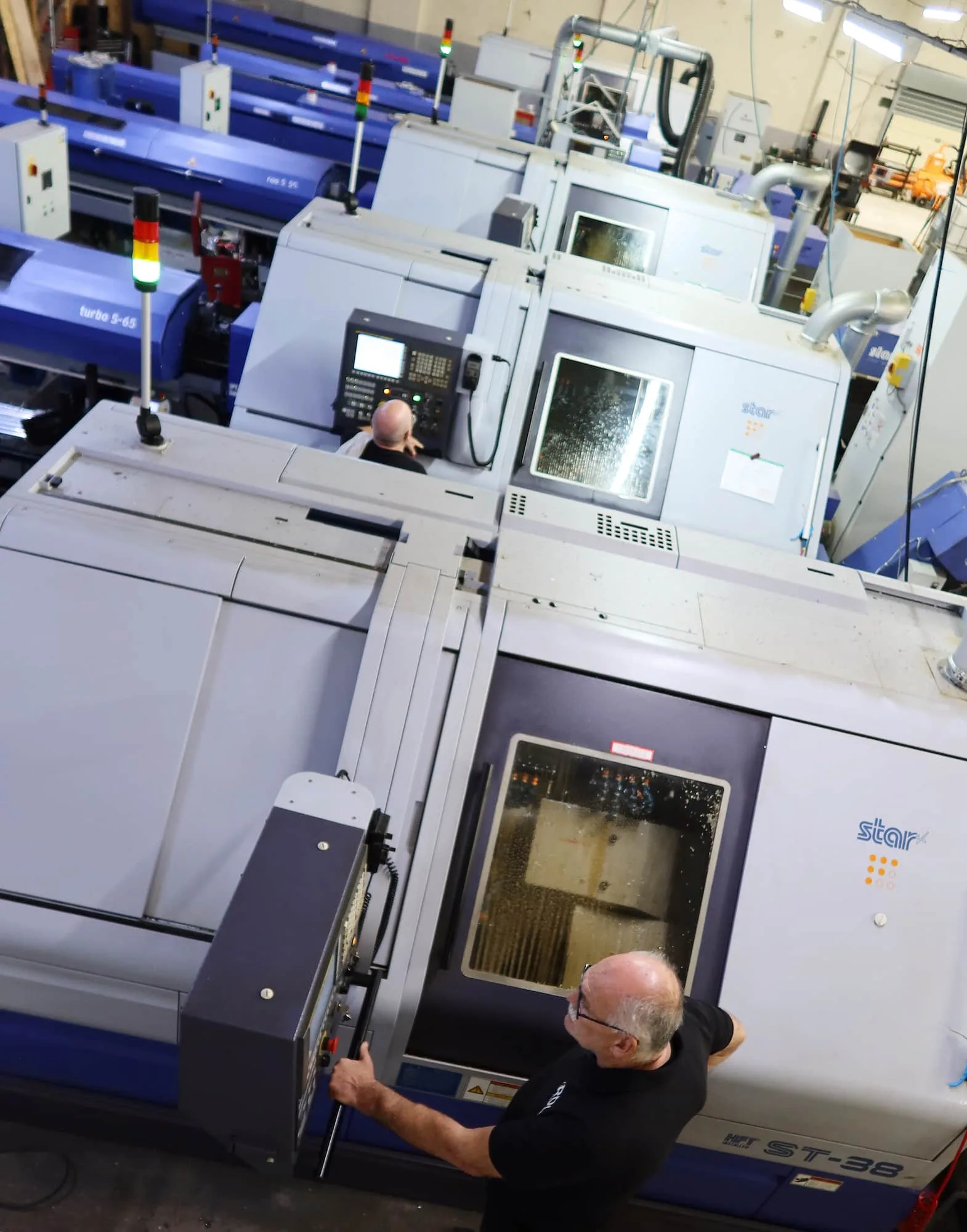 Engineers operating Star CNC sliding head lathes on the shop floor